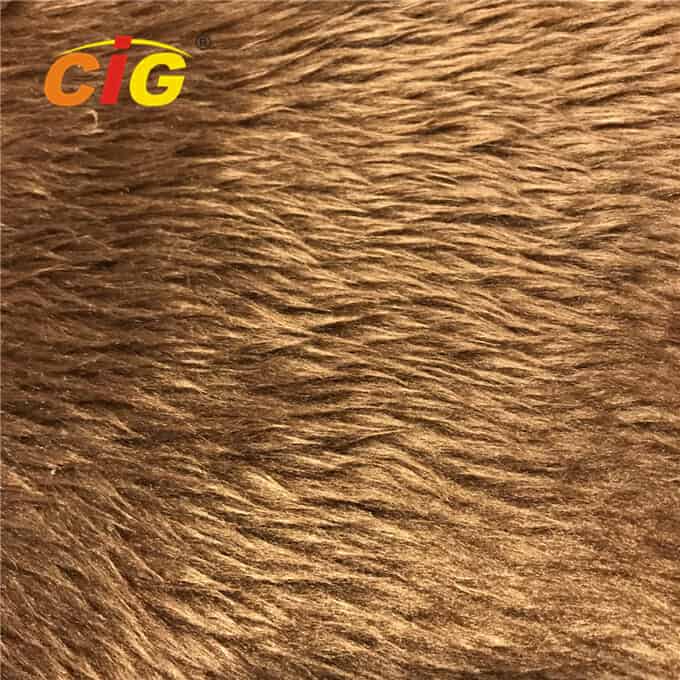 Close-up of textured brown faux fur with the "cig" logo in the upper left corner.